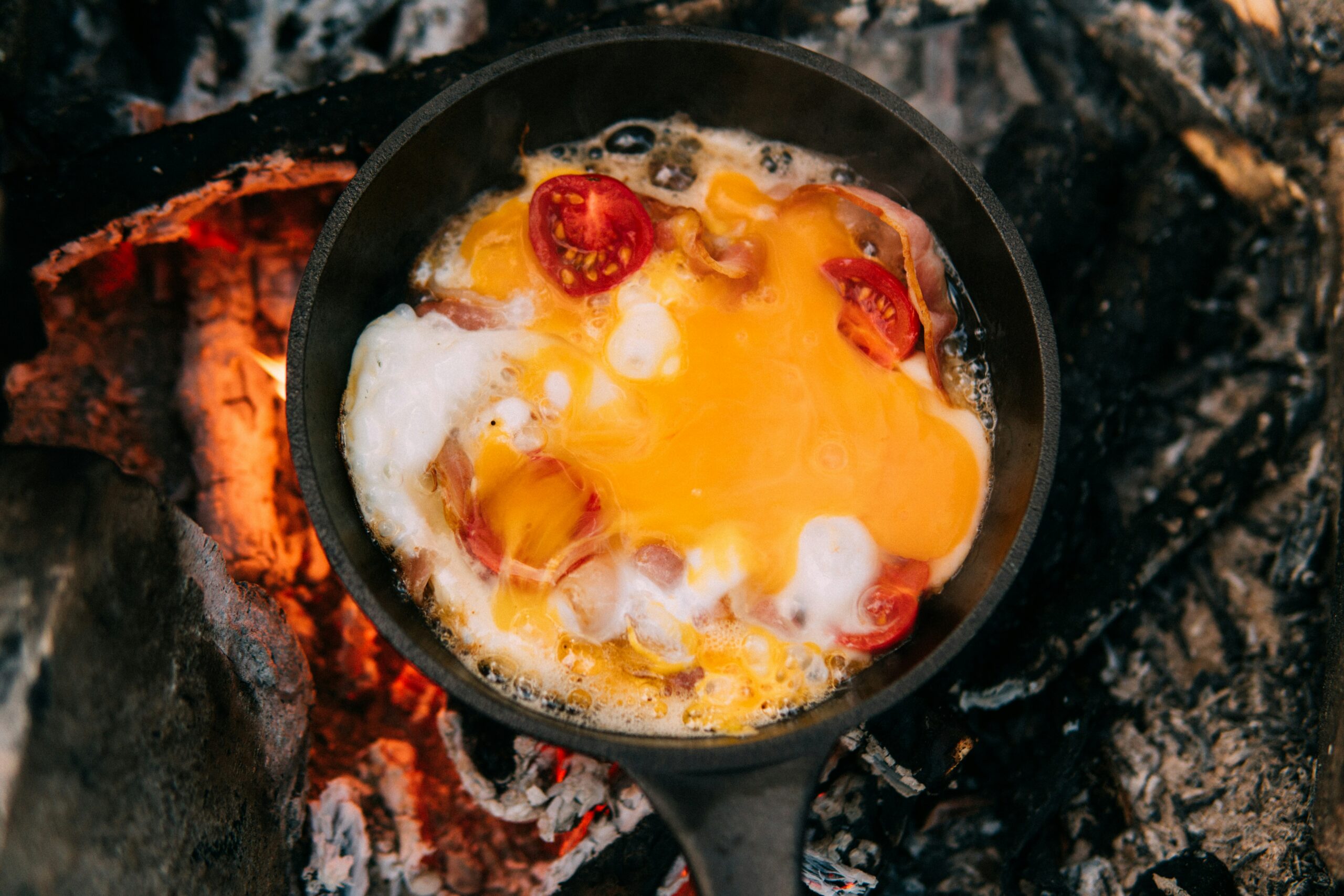 Eggs and bacon dining at the Rainbow Lodge campfire.