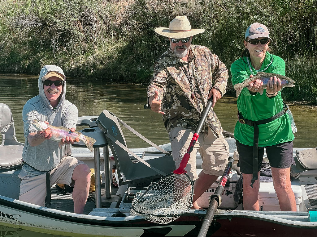 Expert San Juan River fly fishing guides net a trout.