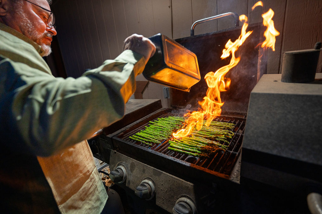 Fresh asparagus grilling over flames for dining at the Rainbow Lodge.